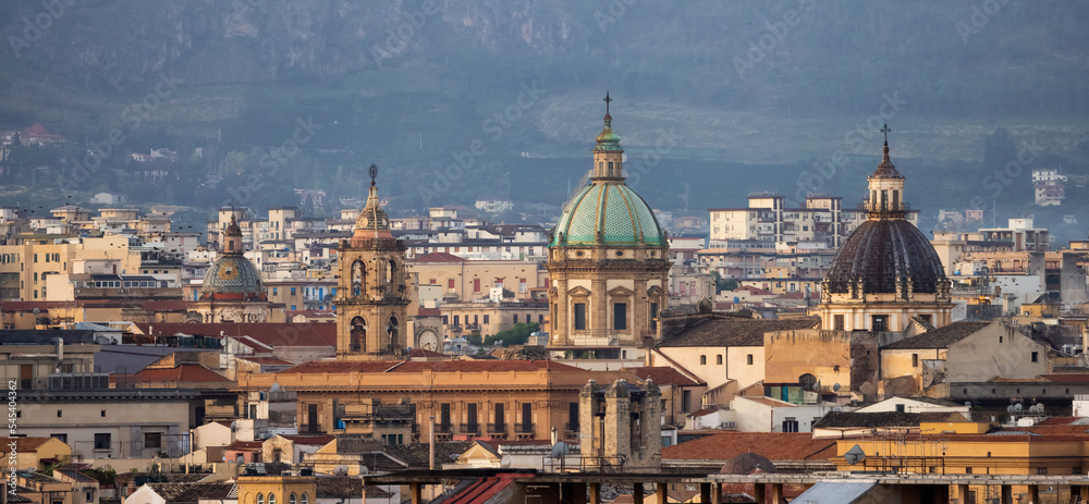 Residential Homes and Historic Church Buildings with mountains in background in Palermo, Sicily, Italy. Sunrise Sky.