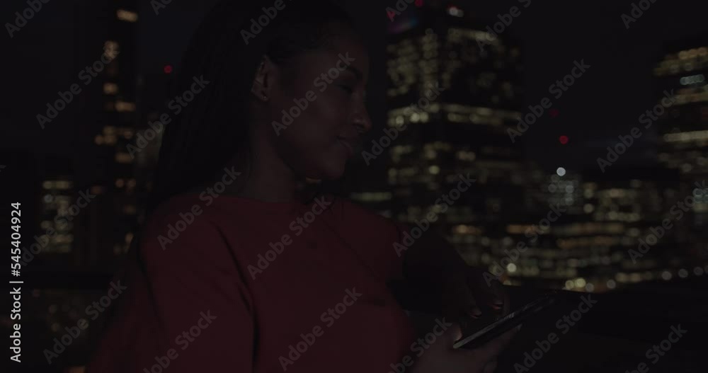 Adult Couple on Date at Rooftop Drinking with City Skyline View at Night Adult Couple on Date at Rooftop Drinking with City Skyline View at Night