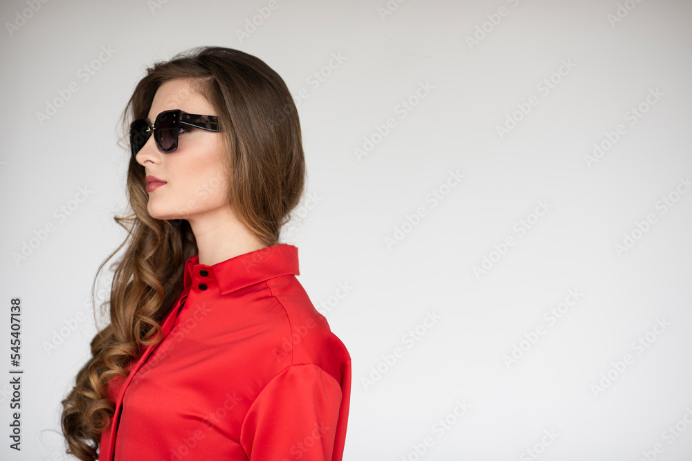 Portrait of a confidence young woman wearing glasses and red shirt, isolated white background. Copy space. Portrait of a confidence young woman wearing glasses and red shirt, isolated white background. Copy space.