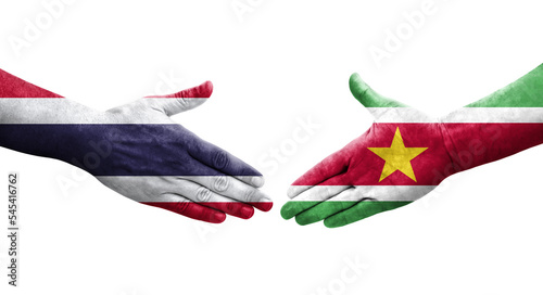 Handshake between Suriname and Thailand flags painted on hands, isolated transparent image.