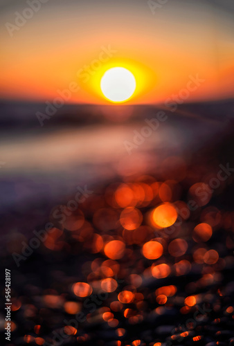 beautiful natural background from the sunset bokeh on the stone seashore