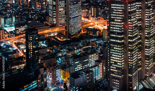 Photography Skyscrapers towering above the cityscape of Nishi-Shinjuku, Tokyo, Japan at nigh
