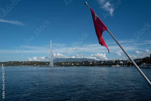 Swiss flag waving against the lake Geneva