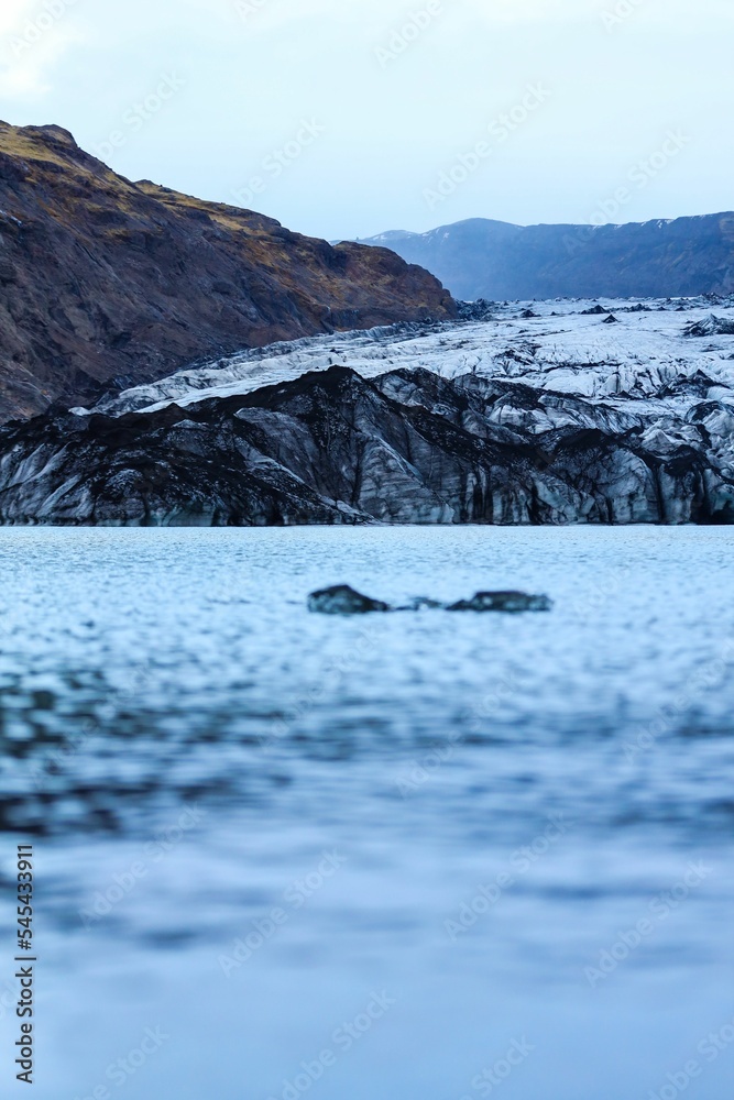 Vertical of the Solheimajokull outlet glacier and a lake in Iceland in winter