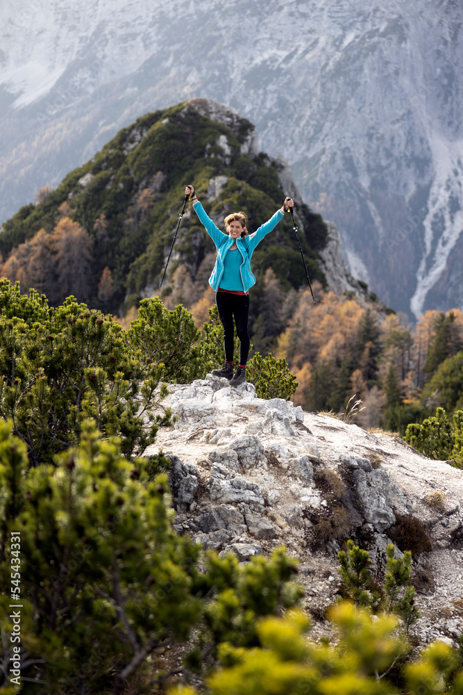 Woman Hiker Showing Happiness of Climbing to the top of a Mountain with Raised Hands