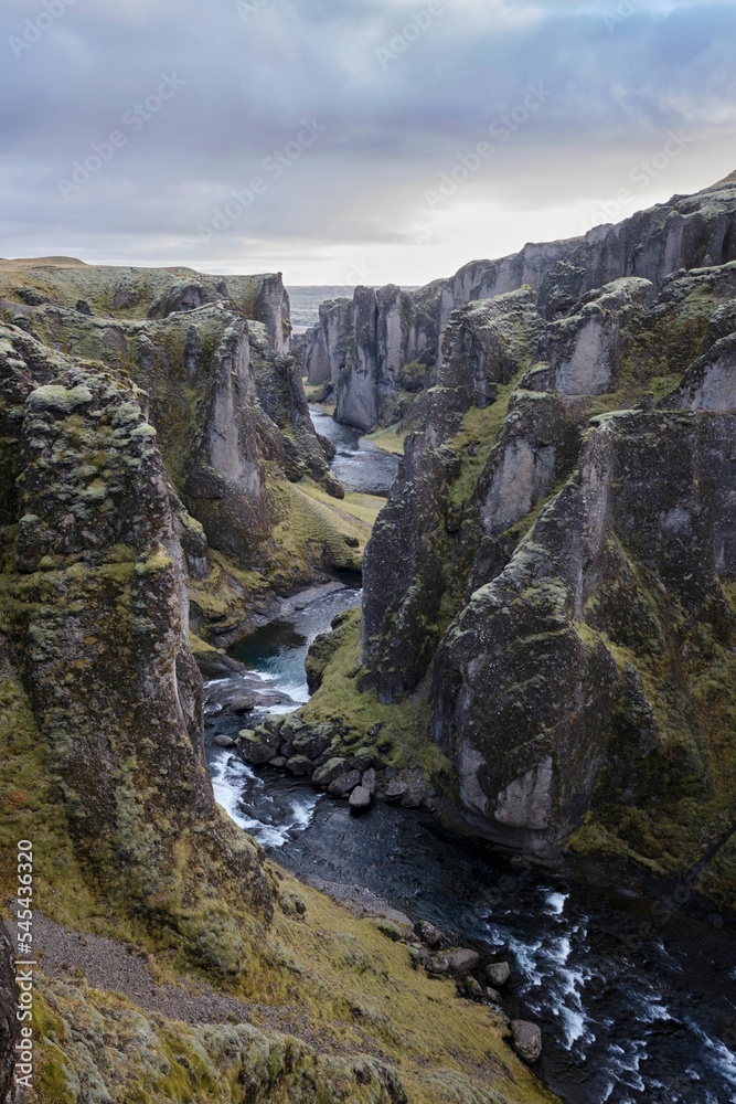 Vertical shot of Fjadrargljufur Canyon during an overcast day in Iceland