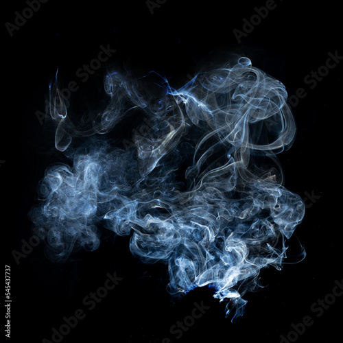 a cloud of whitish-blue-gray smoke on a black background. © Sergey