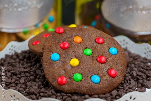 A multi-colored chocolate cookie Homemade on a bed of chocolate chips