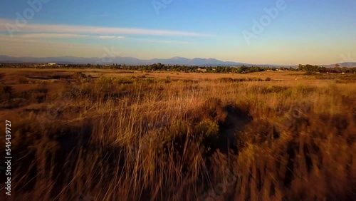 Drone shot of a trail and a landscape during the sunset in Costa Mesa, California, USA photo