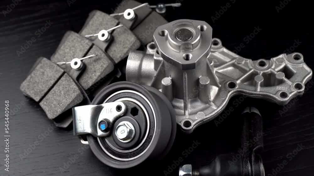 Auto parts spare parts car on grey background. Large number rotate on turntable around its axis. Auto parts store. Suspension and engine parts. Auto parts spare parts car on grey background. Large number rotate on turntable around its axis. Auto parts store. Suspension and engine parts.