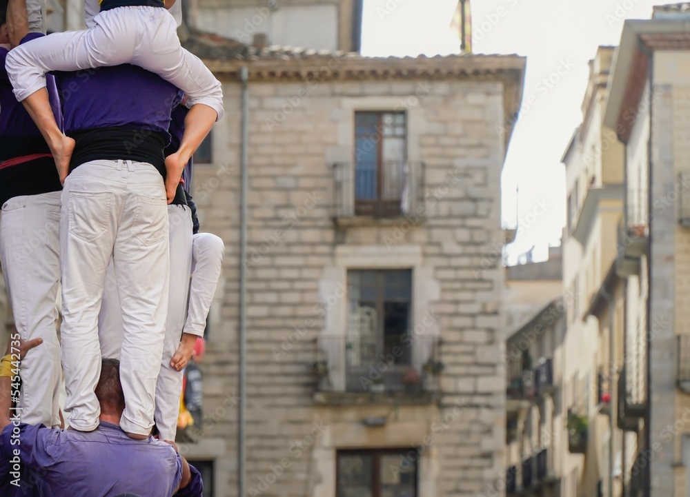 A castellers is a human tower built in festivals in Catalonia.