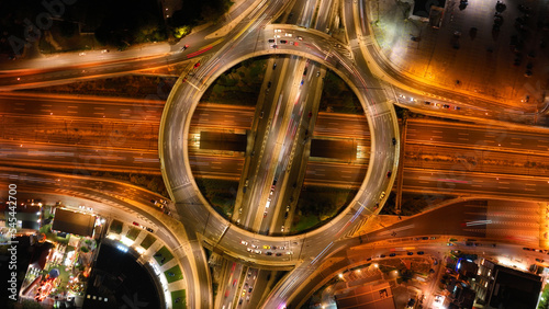 Aerial drone night photo of illuminated urban elevated toll ring road junction and interchange overpass passing through Kifisias Avenue, Attica, Greece photo