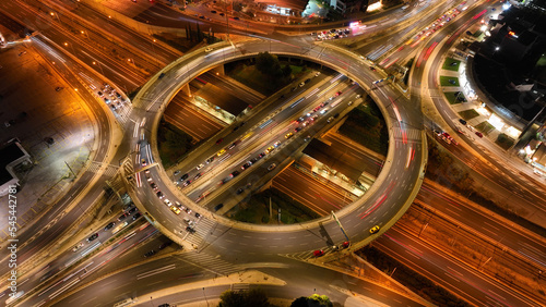 Aerial drone night photo of illuminated urban elevated toll ring road junction and interchange overpass passing through Kifisias Avenue, Attica, Greece