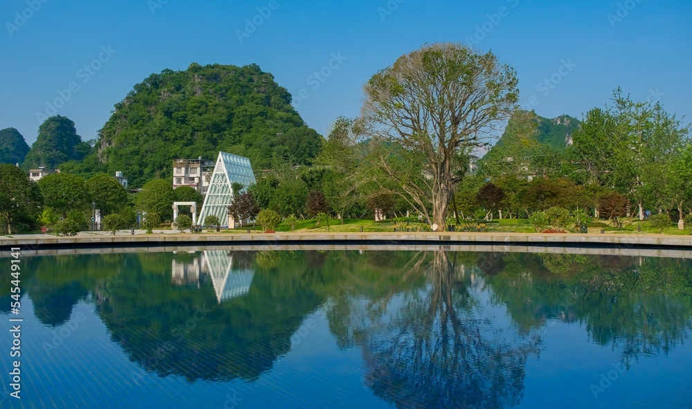 Tree and house reflected on the water lake Tree and house reflected on the water lake