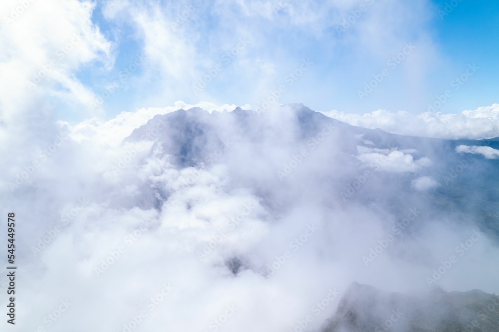 Beautiful shot of mountain peaks in the clouds Beautiful shot of mountain peaks in the clouds