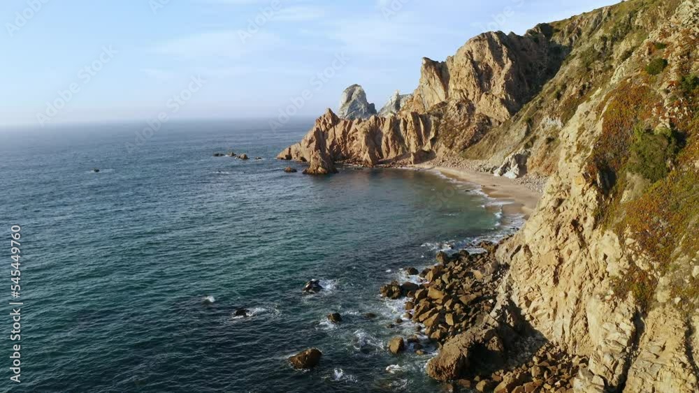 Aerial view of green island with mountain crag rocky cliffs surrounded stormy Atlantic ocean with Ursa deserted beach in Sintra Portugal shoreline panorama wild nature seascape at Europe go everywhere Aerial view of green island with mountain crag rocky cliffs surrounded stormy Atlantic ocean with Ursa deserted beach in Sintra Portugal shoreline panorama wild nature seascape at Europe go everywhere