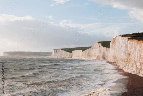Fotografie, Obraz Waves hitting the beach by Seven Sisters chalk cliffs in East Sussex, UK