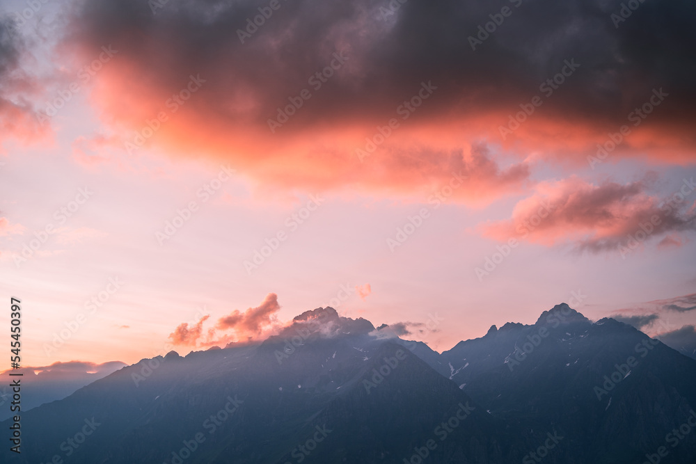 Pink clouds above the peak of Pizzo Redorta during sunset in the Orobie Alps, Northern Italy