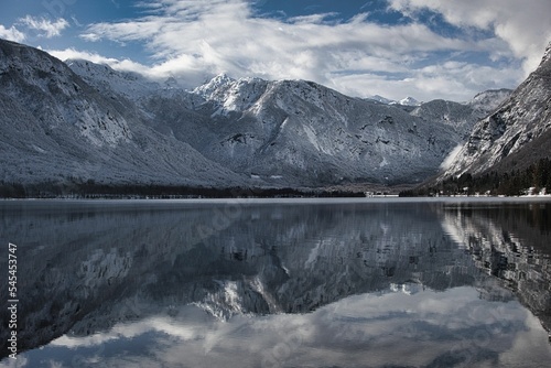Scenic shot of the pure surface of the Talmen lake with the reflection of surrounding mounts on it