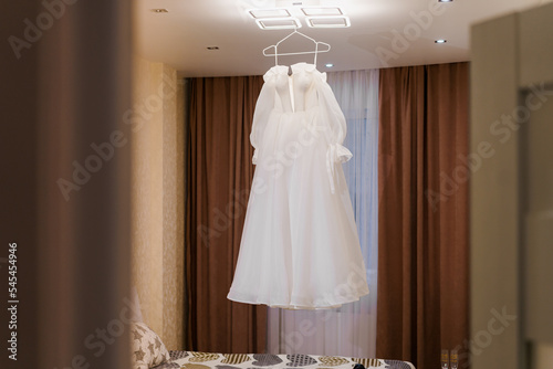 wedding dress hanging on hangers