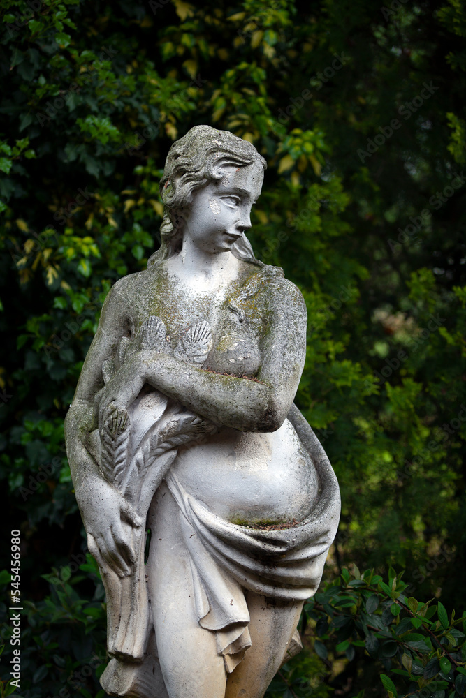 Classical ancient statue of a woman in a backyard garden in summer. Suburb of Venice. Italy