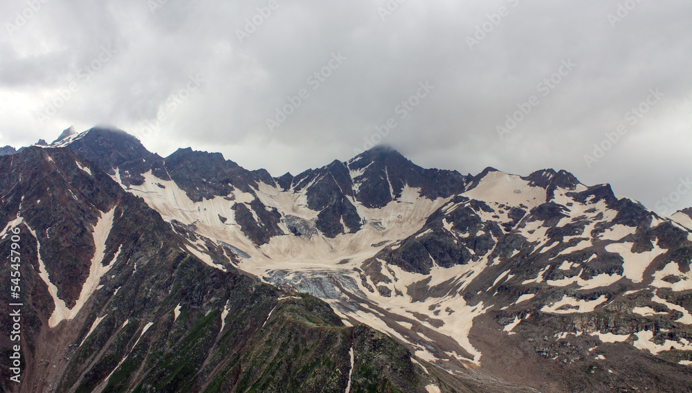 Beautiful harsh landscape - glacier on top of a high mountain on a cloudy day in the Elbrus region in the North Caucasus in Russia