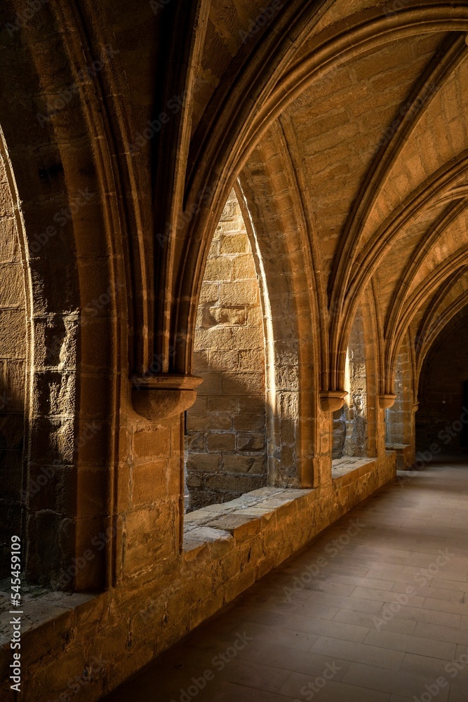 Vertical shot of a corridor of an old stone building