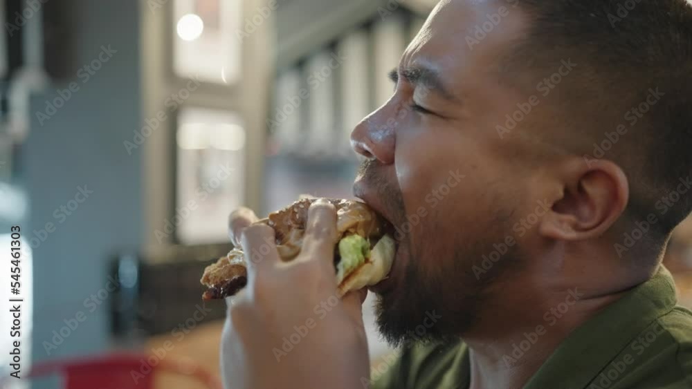 Man Big Mouth Eating Austin Texas BBQ Bacon Burger Angus Beef Patty Mozzarella Pickle Mustard and Onion Rings with French Fries Man Big Mouth Eating Austin Texas BBQ Bacon Burger Angus Beef Patty Mozzarella Pickle Mustard and Onion Rings with French Fries