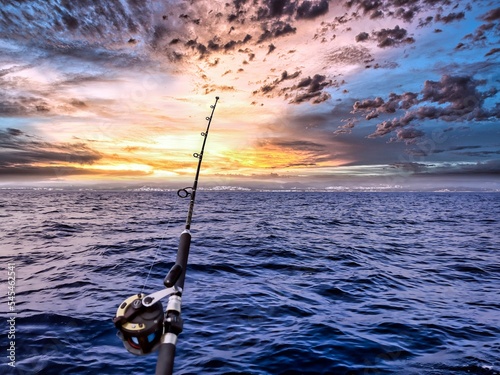 fishing rod and reel anchored to the ship looking for a big catching in a deep seascape offshore