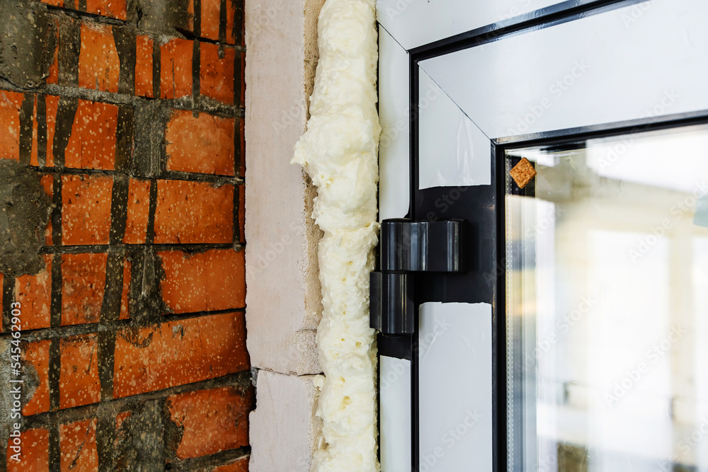 Insulation of the entrance door with mounting foam. Thermal insulation