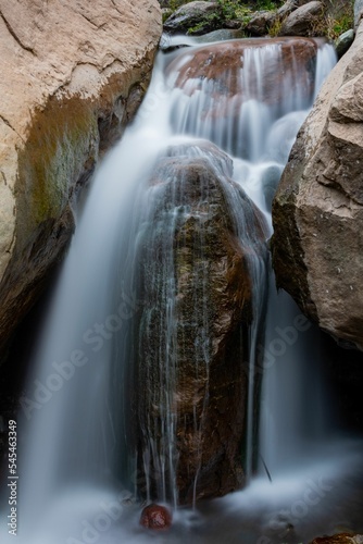 Long exposure shot of a small waterfall full of rocks in the daylight