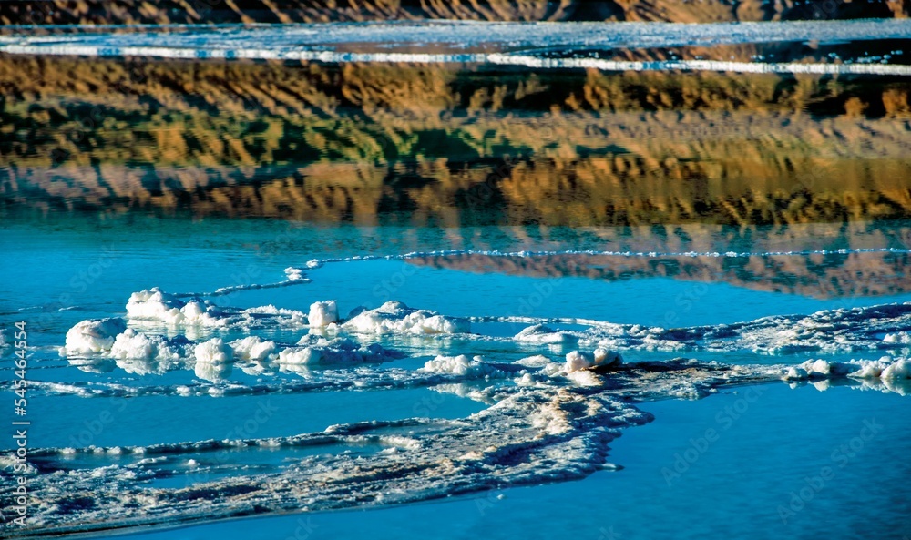 Beautiful view of frozen water with the mountains in the distance. Beautiful view of frozen water with the mountains in the distance.
