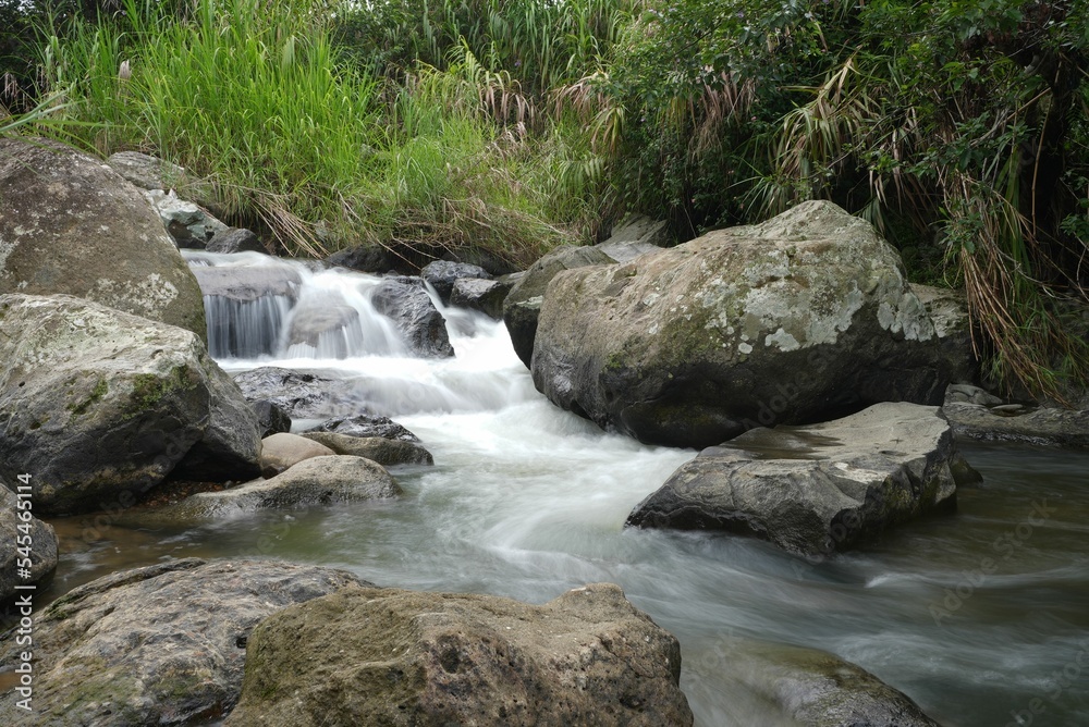 River water flowing on hug rocks, long exposure effect River water flowing on hug rocks, long exposure effect