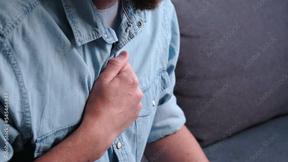 Trouble breathing, chest pain. Close up young man having difficulty