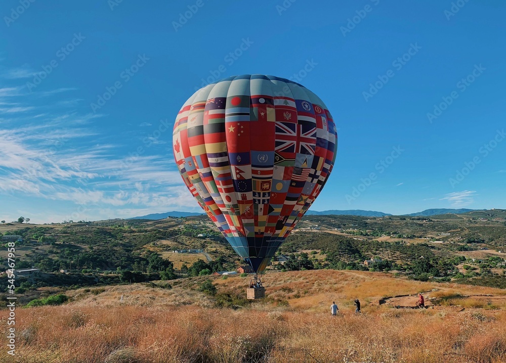 Hot air balloon on the ground ready to float in blue sky