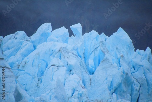 Low angle shot of an iceberg with a blue sky background