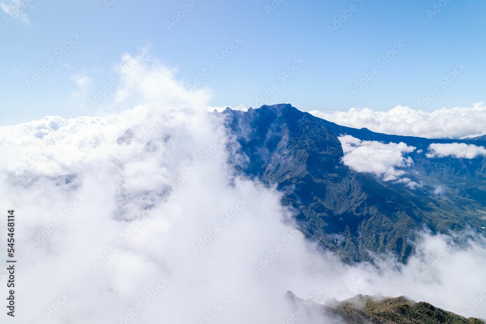 Top of the mountain in the clouds and a blue sky