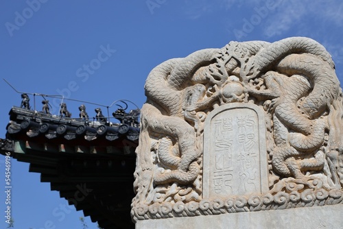 Closeup shot of white Traditional Chinese of stone tablet in Zhihua Temple, Beijing under blue sky photo