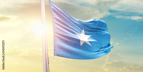 Waving Flag of Somalia in Blue Sky. The symbol of the state on wavy cotton fabric.