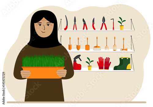 A woman holds a plant in his hands against the background of gardening tools. Gardening concept.