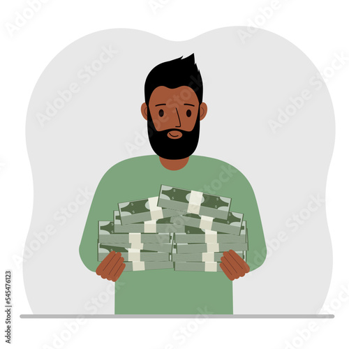 A man is holding a large pile of paper money.