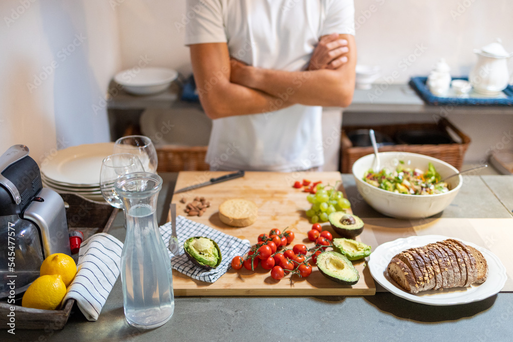 Vegan, plant based breakfast on the table with male in the background Vegan, plant based breakfast on the table with male in the background