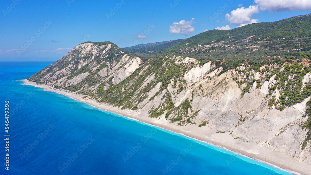 Aerial drone photo of famous paradise beach of Egremni white steep rocky hills overlooking deep turquoise Ionian sea, Lefkada island