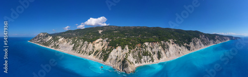 Aerial drone photo of famous paradise beach of Egremni white steep rocky hills overlooking deep turquoise Ionian sea, Lefkada island