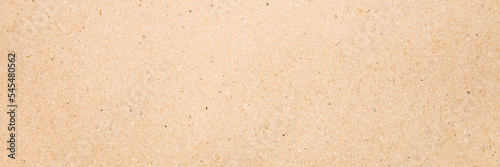 Light brown carton background. Closeup. Material for products packaging. Wide banner. Empty place for text. Top down view.