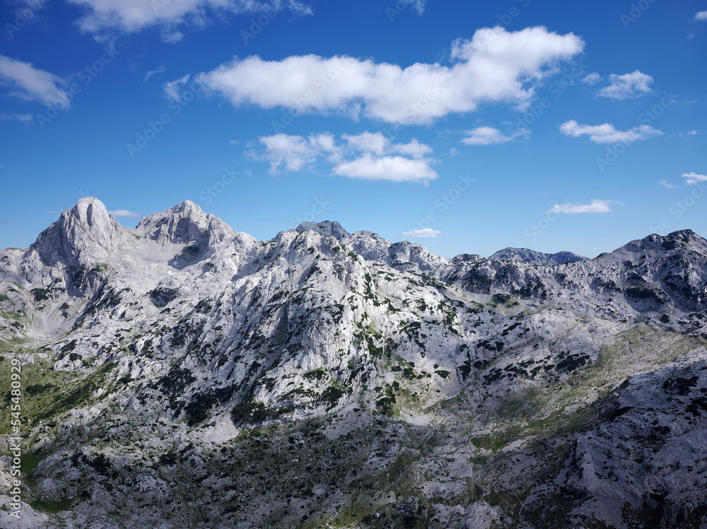 Aerial drone view of different mountain peaks during a beautiful sunny day with a green valley below. Connection with nature, More adventure in life. Prenj Mountain in Bosnia and Herzegovina. 
