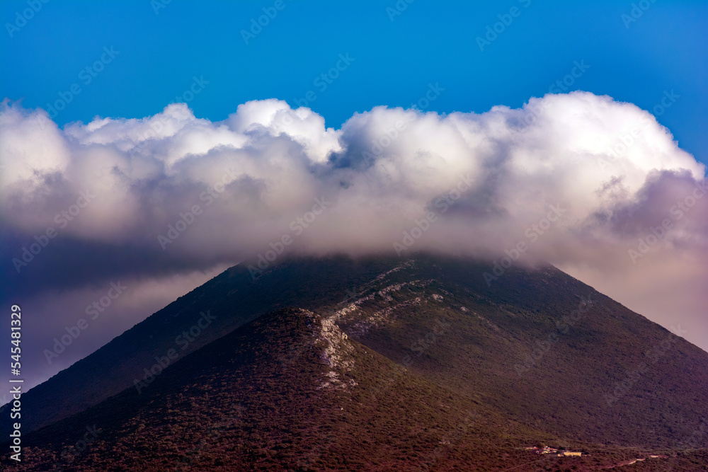 Mountain peak under clouds