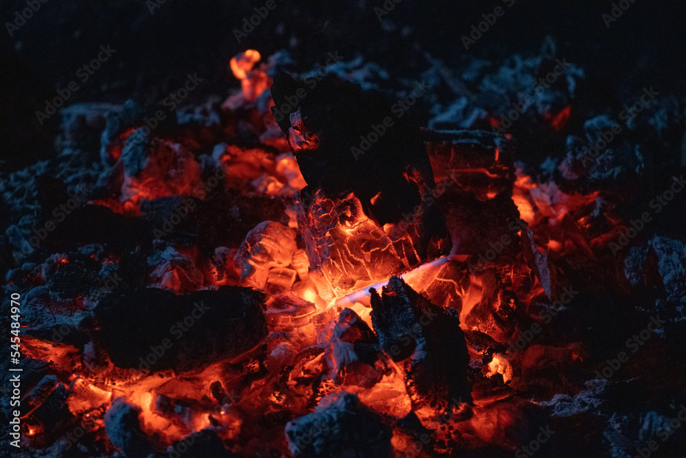 Red orange embers of a camp fire