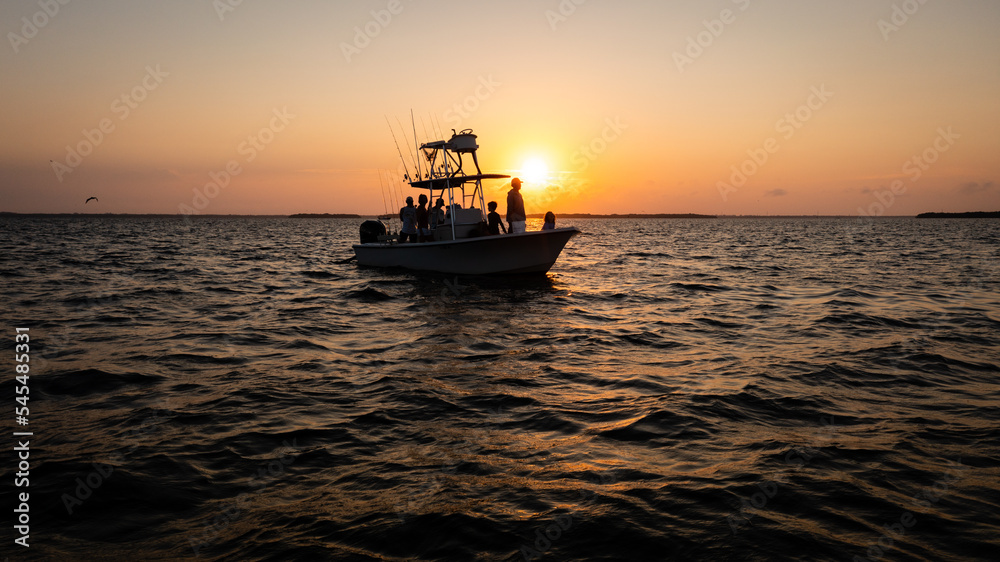 Captiva, FL USA- 9-25-2022: Silhouette of fishermen chumming the water in Pine Island Sound.