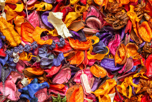 A closeup of colorful dried flowers, fragrant herbs, and plant seedpods used as flower potpourri © Damian Pawlos